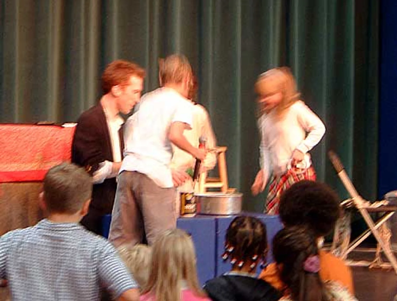 Audience volunteers help make a magic cake
