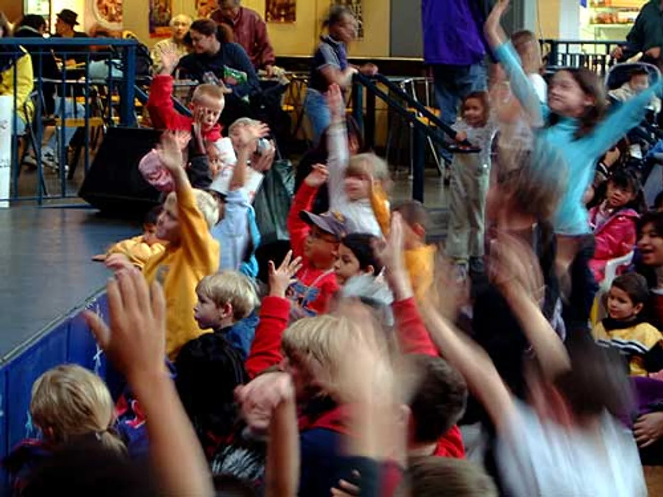 Audience volunteers raising hands