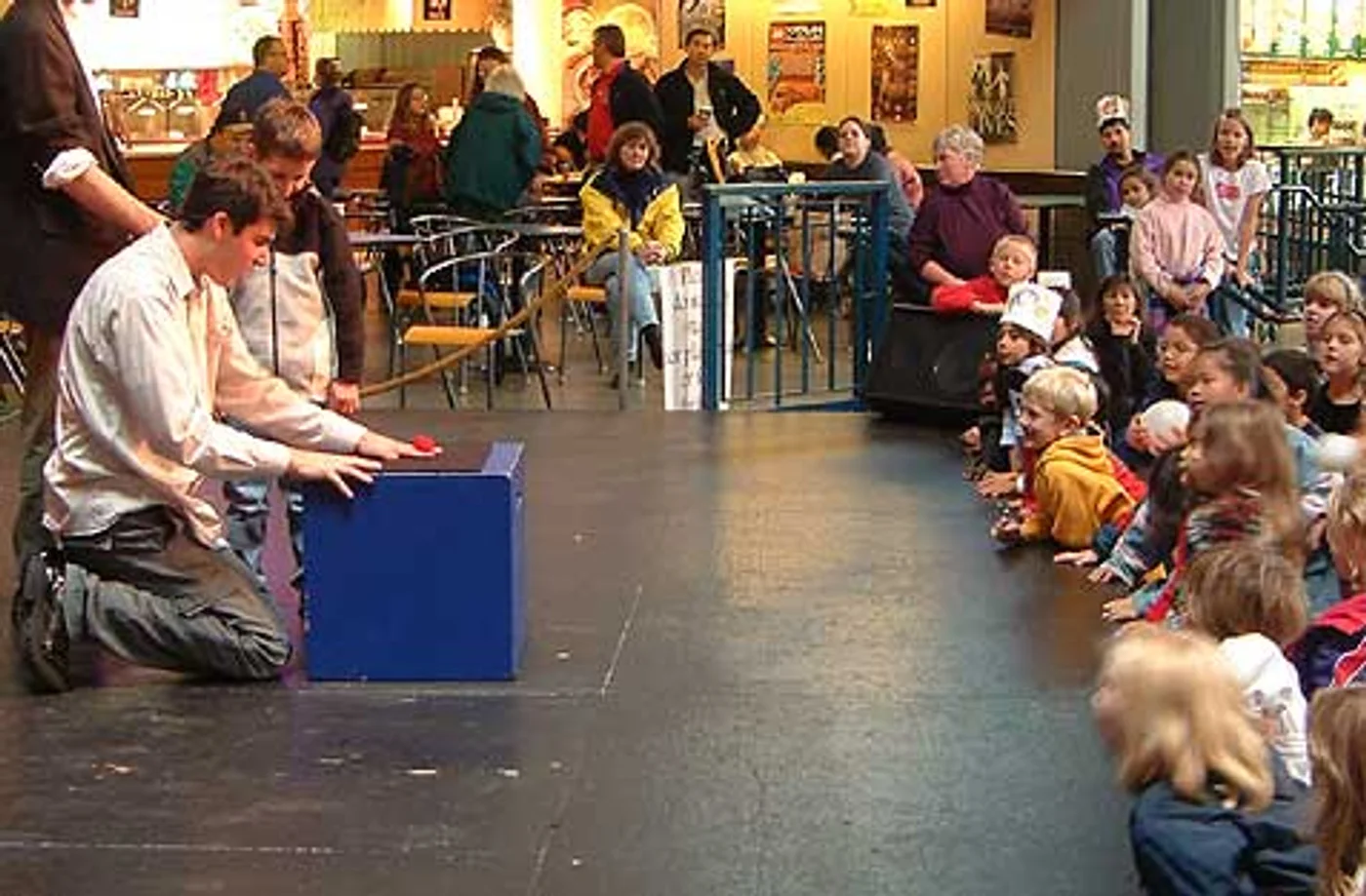 Josh performing the Martians stage routine for a seated audience