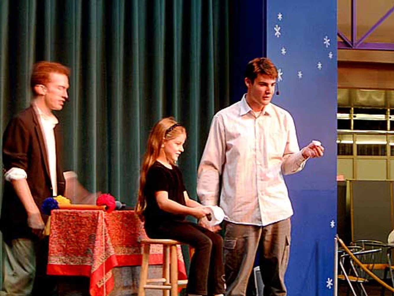 Jacob and audience volunteers performing a comedy toilet paper routine