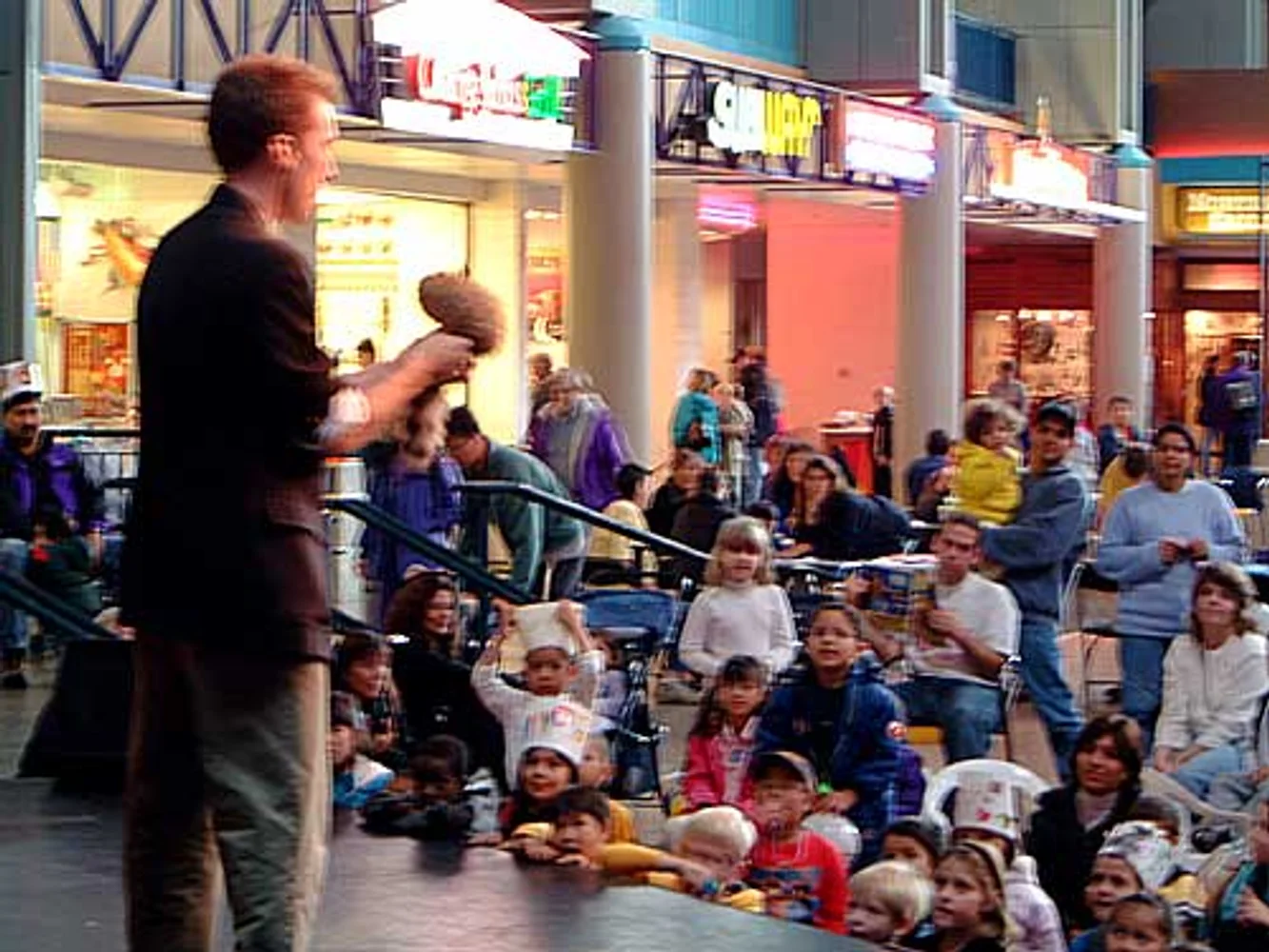 Jacob performing with a puppet character at a public show