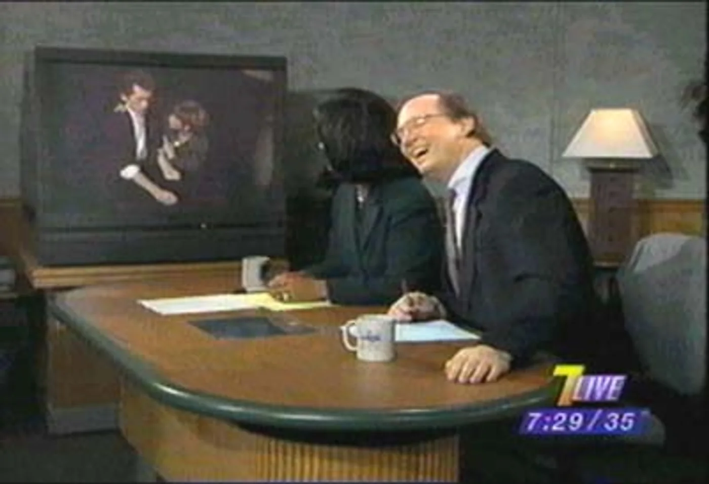 Television host laughing during a magic performance