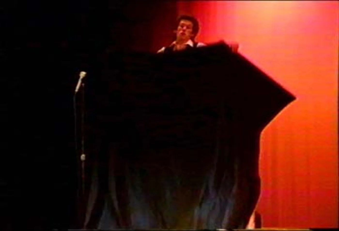 Performer standing atop the secured Metamorphosis crate