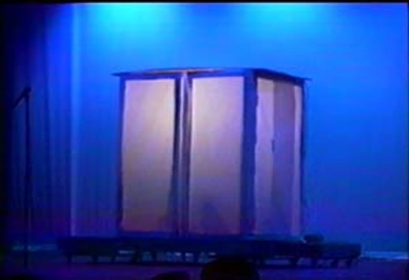 The closed shadow box under theatrical lighting