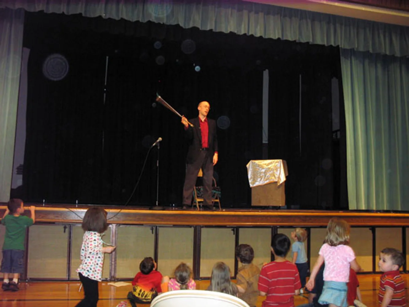 Jacob performing stage magic for children and families