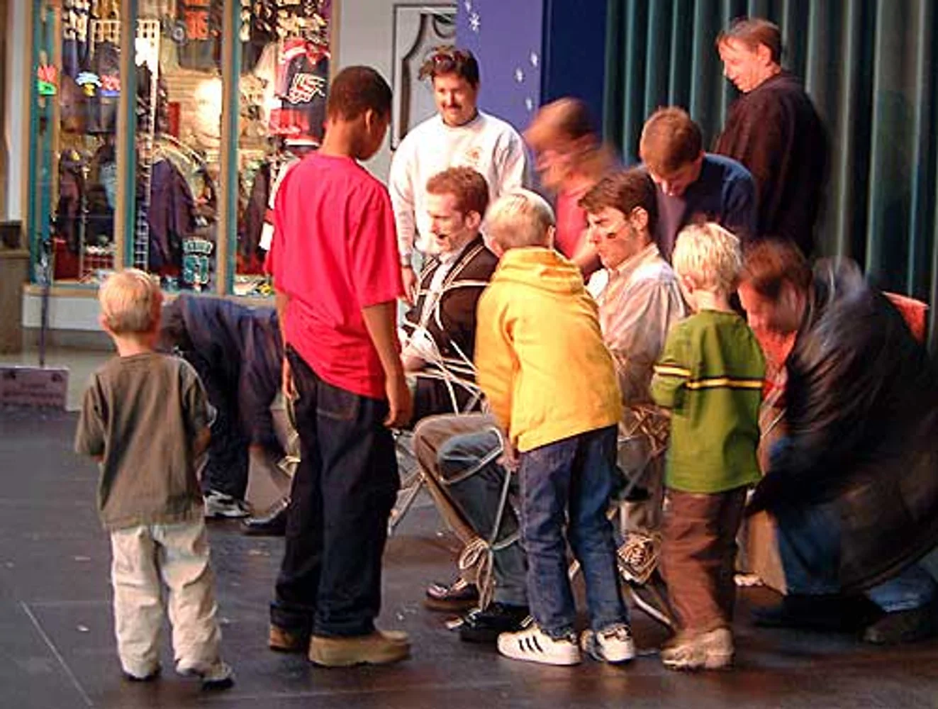 Audience volunteers tying the magicians with rope